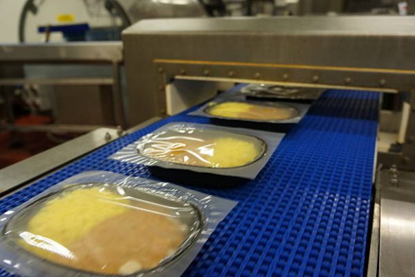 Individual portion curry and rice ready-meals being manufactured in a high speed food factory process